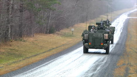 Armored-Personnel-Carrier-Vehicles-Roll-Along-A-Small-Road