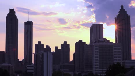 Silhouetted-view-of-skyscrapers-and-high-rises-behind-Atlanta-Georgia-at-sunset