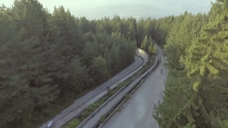 Drone-Vista-Aérea-Of-Bikers-Riding-Fast-In-A-Former-Olympic-Bobseld-Track-Near-Sarajevo-Bosnia-1