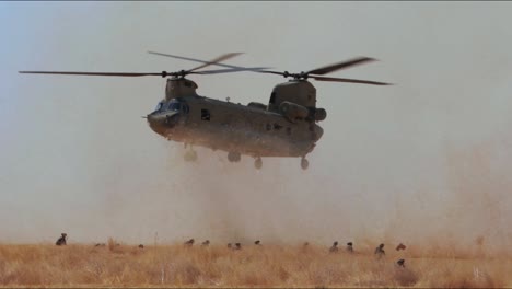 A-Us-Army-Helicopter-Retrieves-Artillery-Equipment-From-A-Field-In-Iraq-And-Takes-Off-With-It