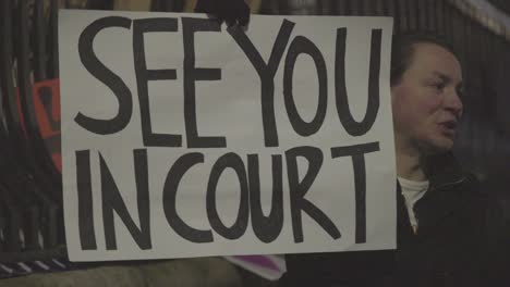 British-Protesters-Holds-A-Sign-Reading-See-You-In-Court-In-A-Huge-Anti-Trump-Rally-In-London