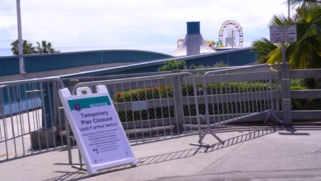 A-Sign-Indicates-The-Santa-Monica-Pier-Is-Closed-During-Covid19-Corona-Virus-Outbreak-Epidemic