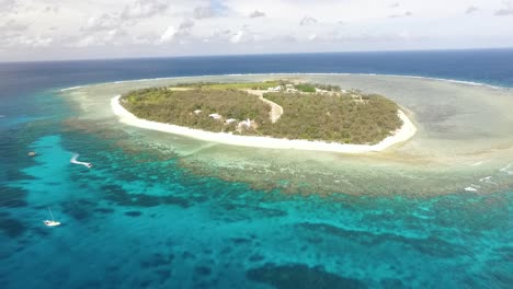 An-aerial-view-shows-people-boating-around-Lady-Elliot-Island-a-coral-cay-of-the-Great-Barrier-Reef-in-Australia