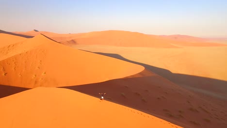 A-tourist-is-seen-at-the-top-of-a-sand-dune-in-Namibia-Southern-Africa