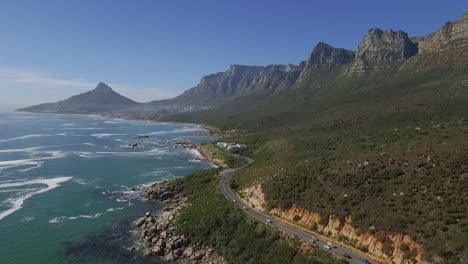 An-aerial-view-shows-cars-driving-along-the-seaside-resort-of-Oudekraal-in-Cape-Town-South-Africa
