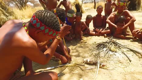 African-San-tribal-bushmen-make-fire-the-traditional-way-in-a-small-primitive-village-in-Namibia-Africa