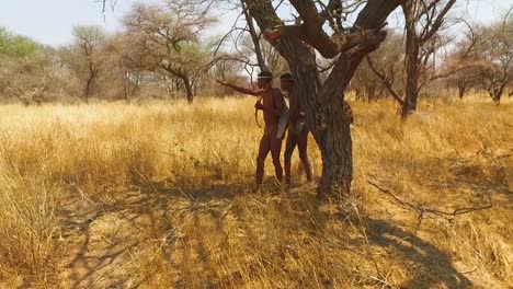 San-tribal-bushman-hunters-in-Namibia-Africa-walk-quiety-sniff-the-air-and-sample-the-soil-for-wind-direction-hunting-for-prey-4