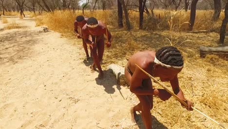 San-tribal-bushman-hunters-in-Namibia-Africa-walk-quiety-sniff-the-air-and-sample-the-soil-for-wind-direction-hunting-for-prey-8