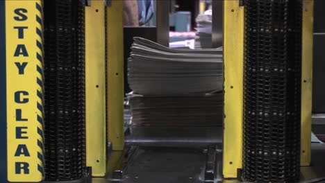 A-machine-stacks-and-binds-newspapers-in-a-factory