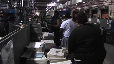 Workers-in-a-newspaper-factory-sort-and-stack-papers