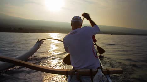 Slow-motion-of-kayaks-or-outriggers-rowing-into-sunset
