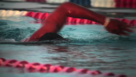 Side-view-of-a-swimmer-in-lanes-in-a-pool