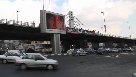 A-busy-thoroughfare-in-a-city-in-Iran-with-a-modern-digital-billboard