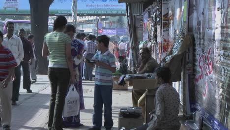 A-young-boy-wants-to-buy-something-from-a-street-vendor-and-his-mother-buys-it-for-him