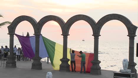 Gay-pride-flag-being-hung-from-the-arches-down-town-in-Puerto-Vallarta-beach-resort