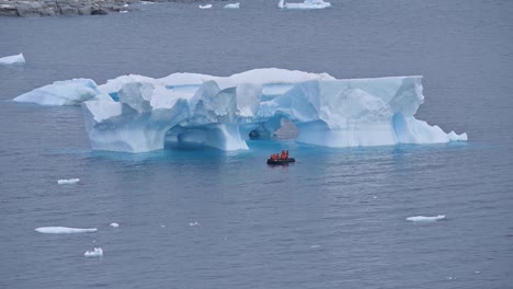 Tourists-visit-Antarctica-Booth-Island-icebergs-via-zodiac-raft
