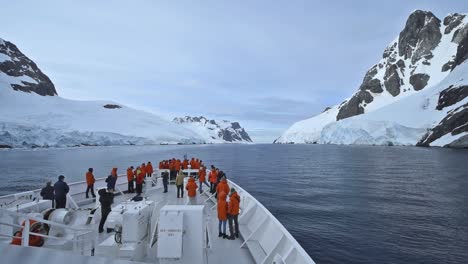 Antarctica-Lermiere-Pass-cruise-ship-bow-POV-with-many-tourists-on-deck