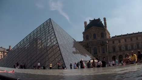 Crowds-of-people-walk-around-the-grounds-of-Louvre-in-Paris-1