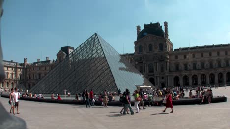Handheld-shot-of-people-walking-in-front-of-the-Louvre-in-Paris