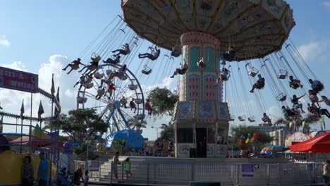A-merry-go-round-spins-with-riders-against-the-sky