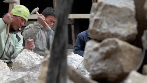 Slow-pan-of-stone-masons-chiseling