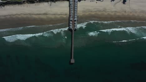 Aerial-of-empty-abandoned-pier-in-southern-california-with-no-one-during-covid19-coronavirus-epidemic-as-people-stay-home-en-masse