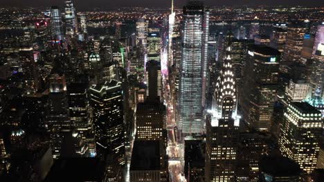An-aerial-view-shows-the-skyline-of-42nd-Street-in-New-York-City-New-York-at-night-highlighting-the-Chrysler-Building