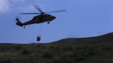 A-Water-Dropping-Helicopter-Picks-Up-Water-For-An-Airdrop-During-A-Wildland-Firefighting-Exercise-1