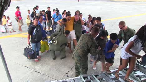Injured-Philippine-Refugees-Are-Led-Onto-A-Us-Cargo-Plane-During-Typhoon-Haiyan