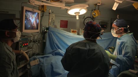 A-Surgery-Is-Performed-In-A-Darkened-Operating-Room-2