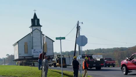A-Church-Is-Moved-Down-A-Highway-On-The-Back-Of-A-Flatbed-Trailer-In-Time-Lapse