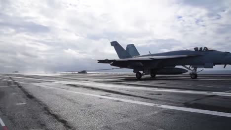 A-Fighter-Jet-Lands-On-The-Deck-Of-An-Aircraft-Carrier