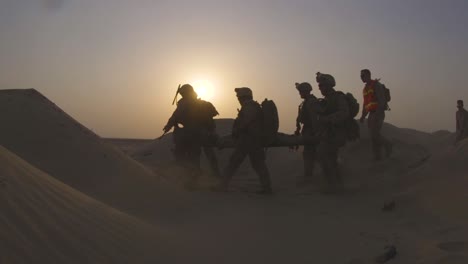 Us-Marines-Carry-A-Man-With-Simulated-Injuries-Through-The-Desert-As-Part-Of-A-Rescue-Training-Exercise