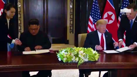 Us-President-Donald-Trump-And-North-Korean-Dictator-Kim-Jong-Un-Sign-A-Document-During-Their-Historic-Singapore-Summit-Meeting