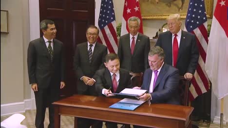 Executives-From-Boeing-And-Singapore-Airlines-Meet-In-The-White-House-To-Sign-A-Deal-For-Aircraft-Under-The-Watchful-Eye-Of-President-Donald-Trump-1