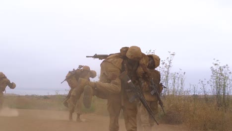 Squad-Leader-Soldiers-Carry-Marines-On-Their-Backs-During-Basic-Training-Exercises-At-The-Marine-Corps-Recruit-Depot-In-San-Diego-California