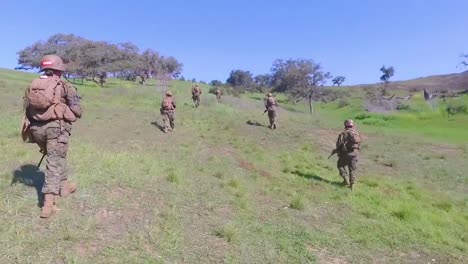 Los-Infantes-De-Marina-Caminan-A-Través-De-Un-Campo-Abierto-Durante-La-última-Formación-Básica-De-Ejercicios-De-Infantería-Del-Ejército