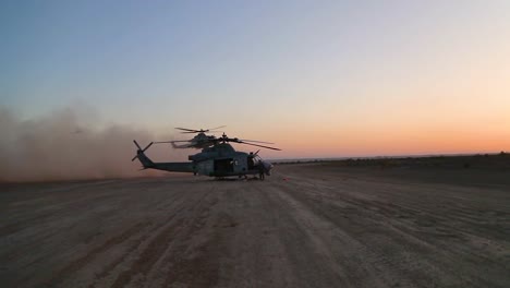 Huey-Helicopters-Land-In-Formation-In-The-Desert-In-This-Slow-Motion-Action-Scene