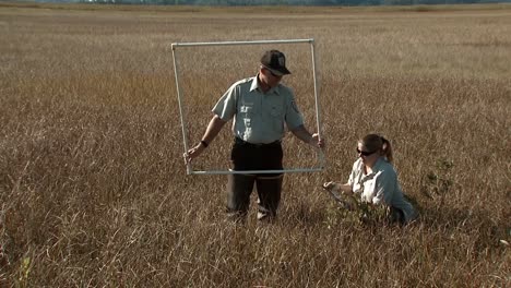 A-Man-And-Woman-Of-The-Usfws-Manage-Water-Levels-In-Delaware'S-Bombay-Hook-National-Wildlife-Refuge