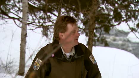 A-Refuge-Law-Enforcement-Officer-Navigates-A-Wintry-Landscape-On-Snowshoes-And-A-Snow-Mobile