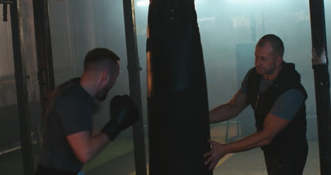 Man-Boxing-Punching-Bag-in-Gym-01