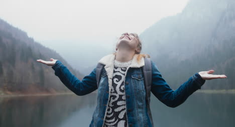 Crane-Shot-of-Female-Hiker-and-Lake