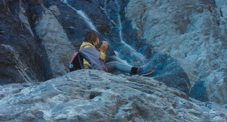 Hiker-Eating-Picnic-by-Waterfall-03