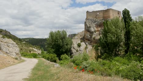 Spain-Alto-Tajo-Castle-On-Rock-With-Road-And-Poppies