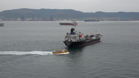 Spain-Boat-Passes-Freighter-In-The-Mediterranean-Off-Gibraltar