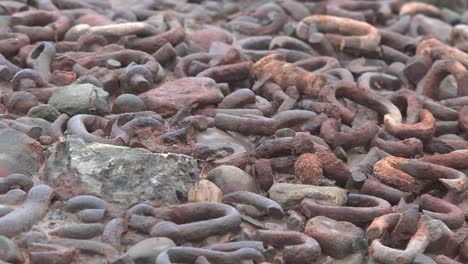 Canada-Nova-Scotia-Rusted-Chain-Links-On-Ground-Pan