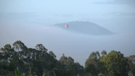 Australia-Outlook-Hill-With-Balloon-Descending-Toward-Mist