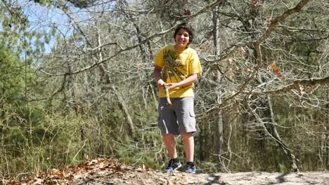 Virginia-Boy-Plays-With-Stick-In-Woods