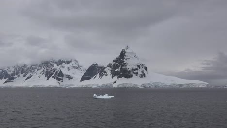 Antarctica-Lemaire-Horn-With-Small-Iceberg