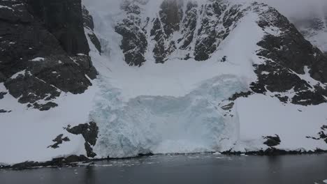 Antarctica-Lemaire-Passing-Rock-And-Ice